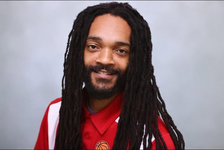 Professional portrait of Hemp the Artist in a red collared shirt